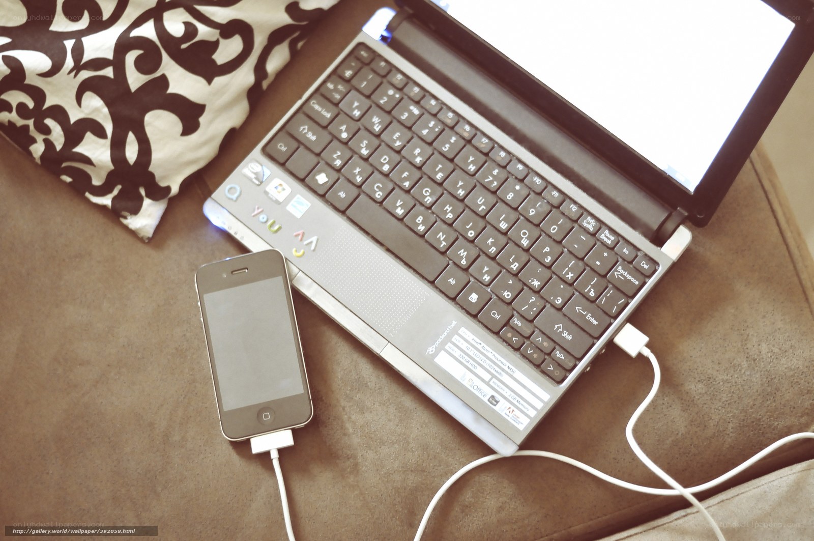 laptop and smartphone on couch