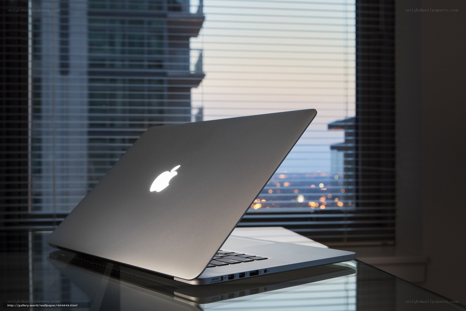 Laptop by a city window
