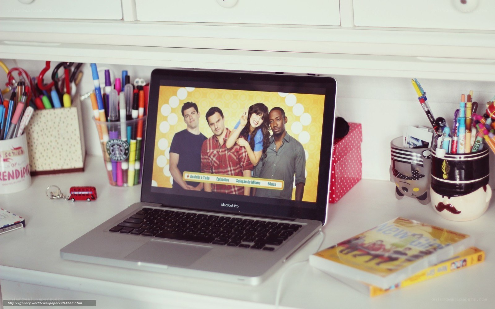 laptop displaying tv show on desk