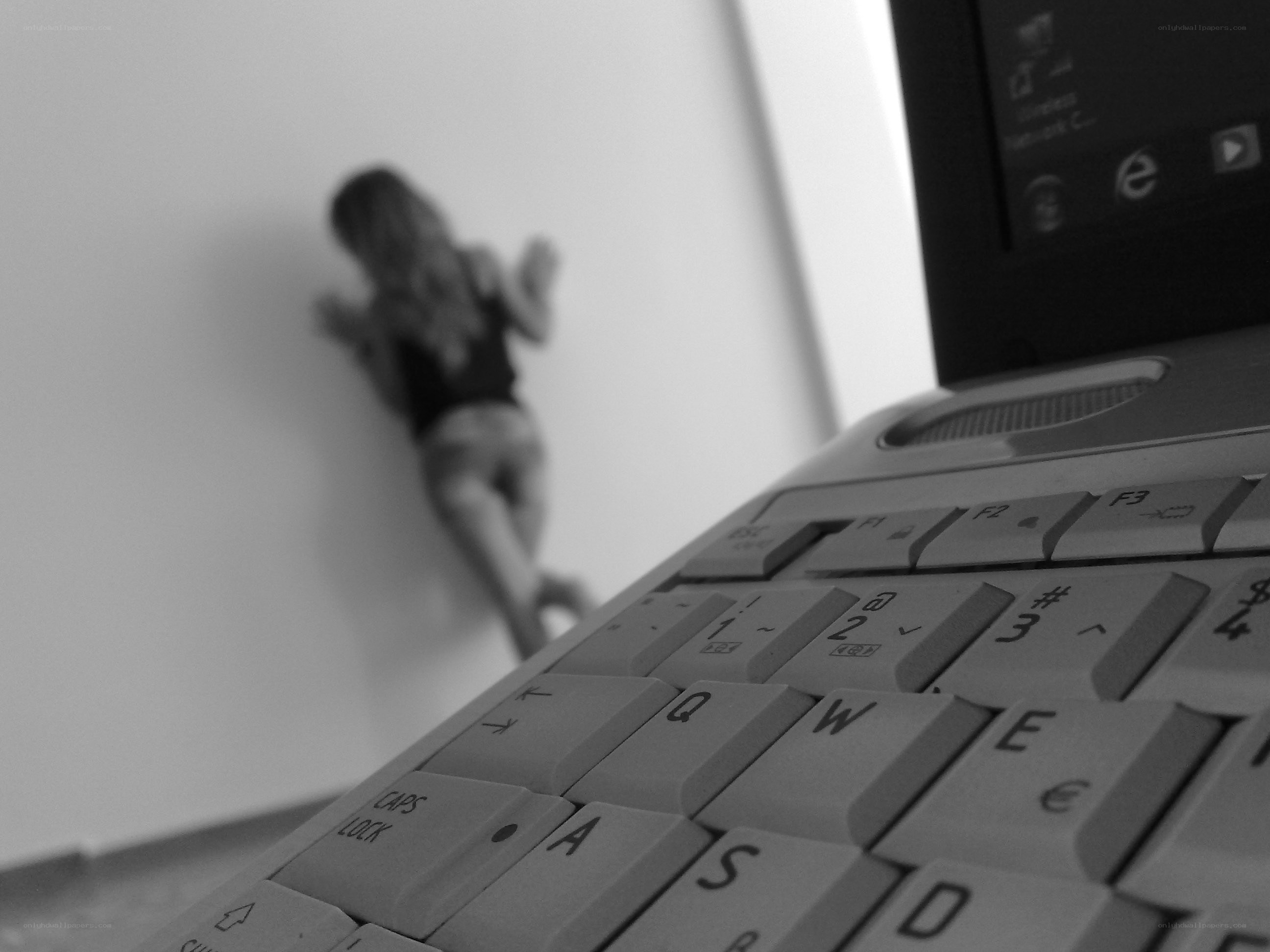 laptop keyboard with blurred figure