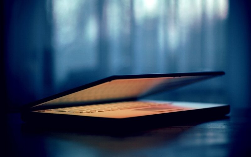laptop on a dark table