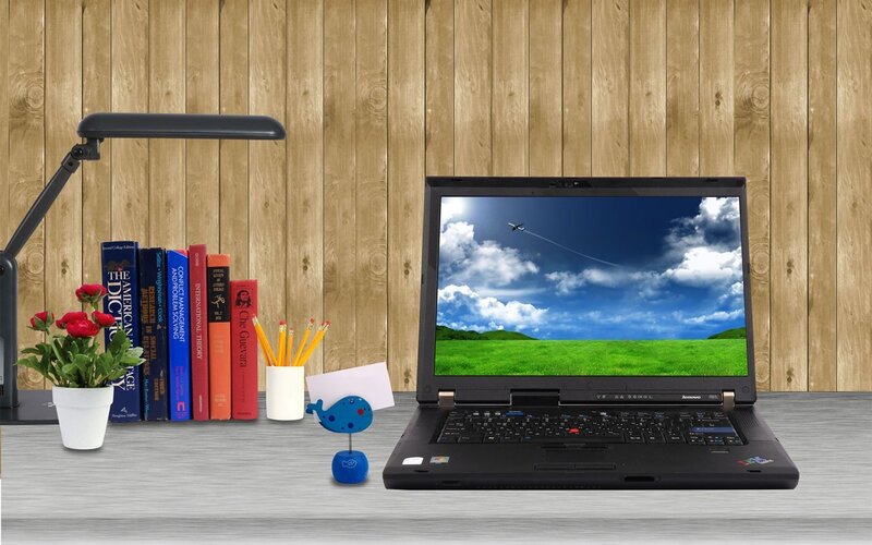 laptop on a desk with books