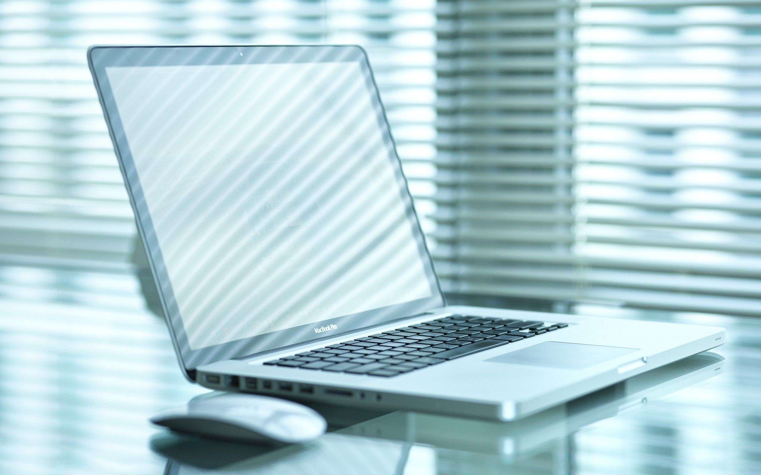 laptop on glass desk