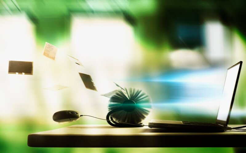 Laptop with flying papers