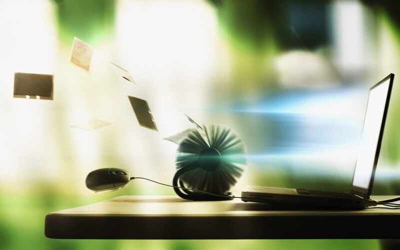 Laptop with flying papers