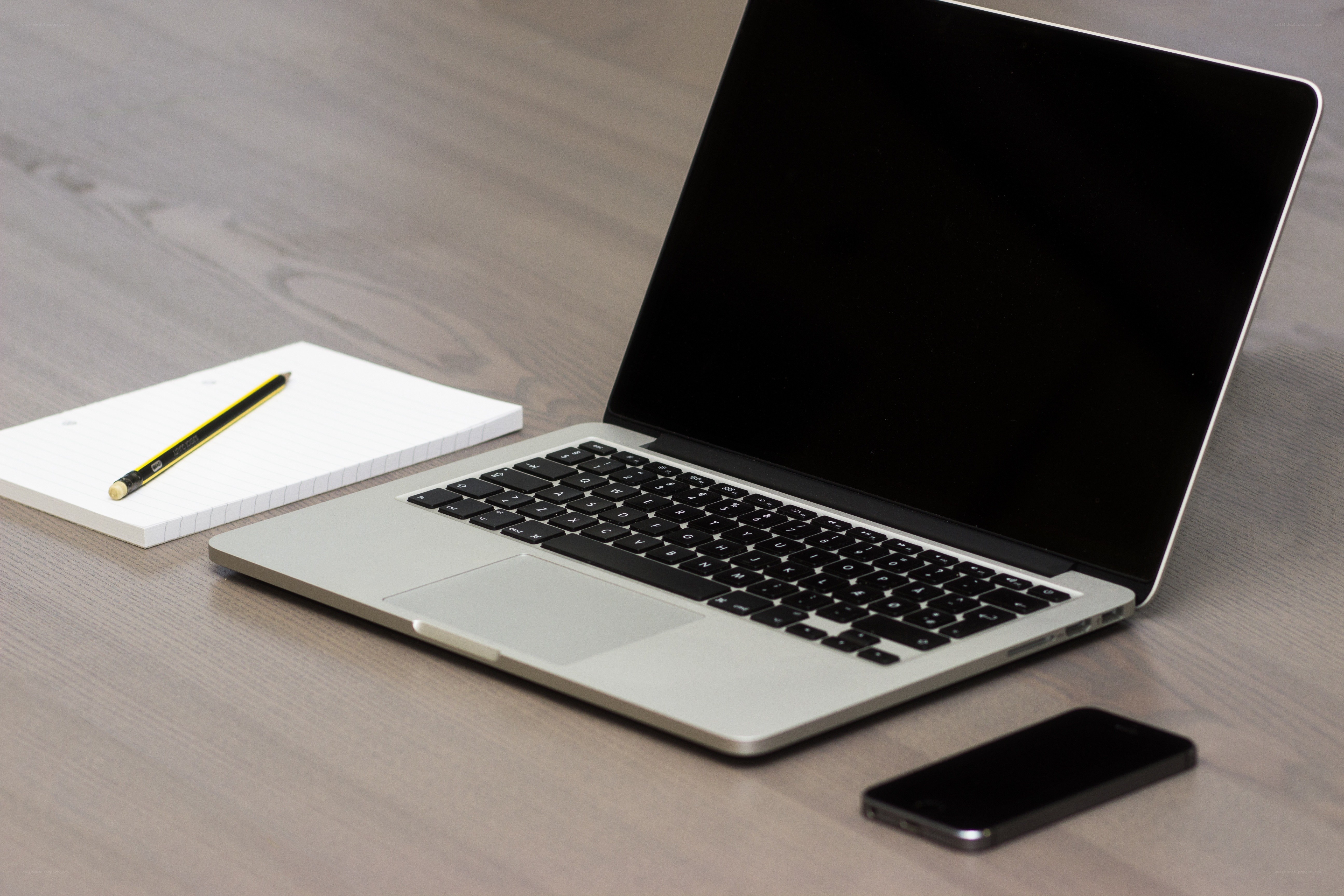 laptop with notebook and phone