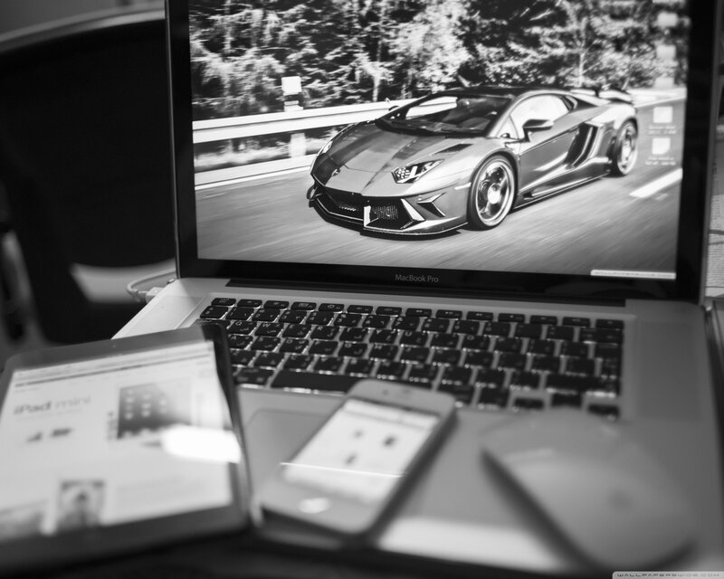 Laptop with sports car wallpaper
