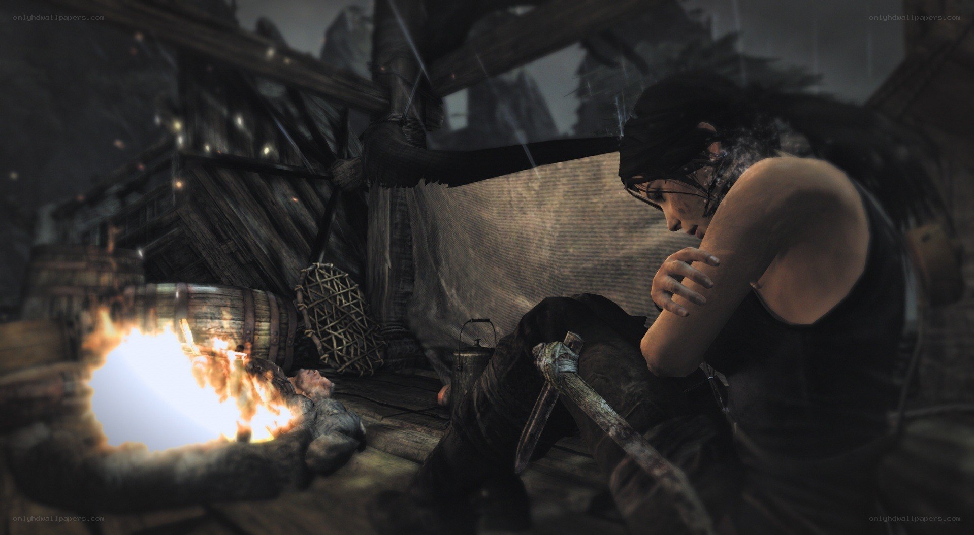 Lara Croft by a campfire