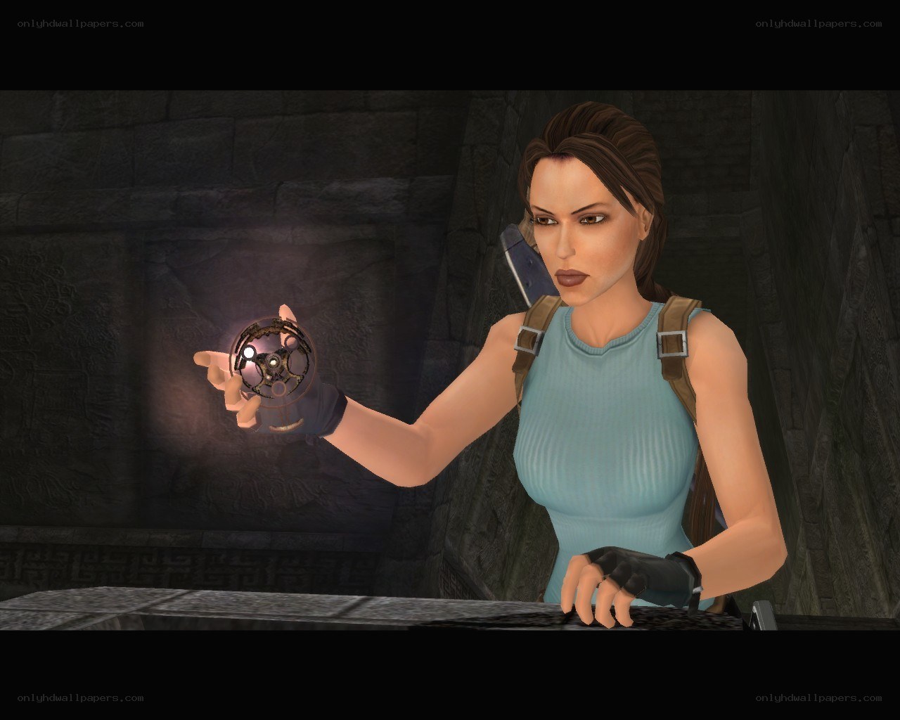 Lara Croft holding artifact