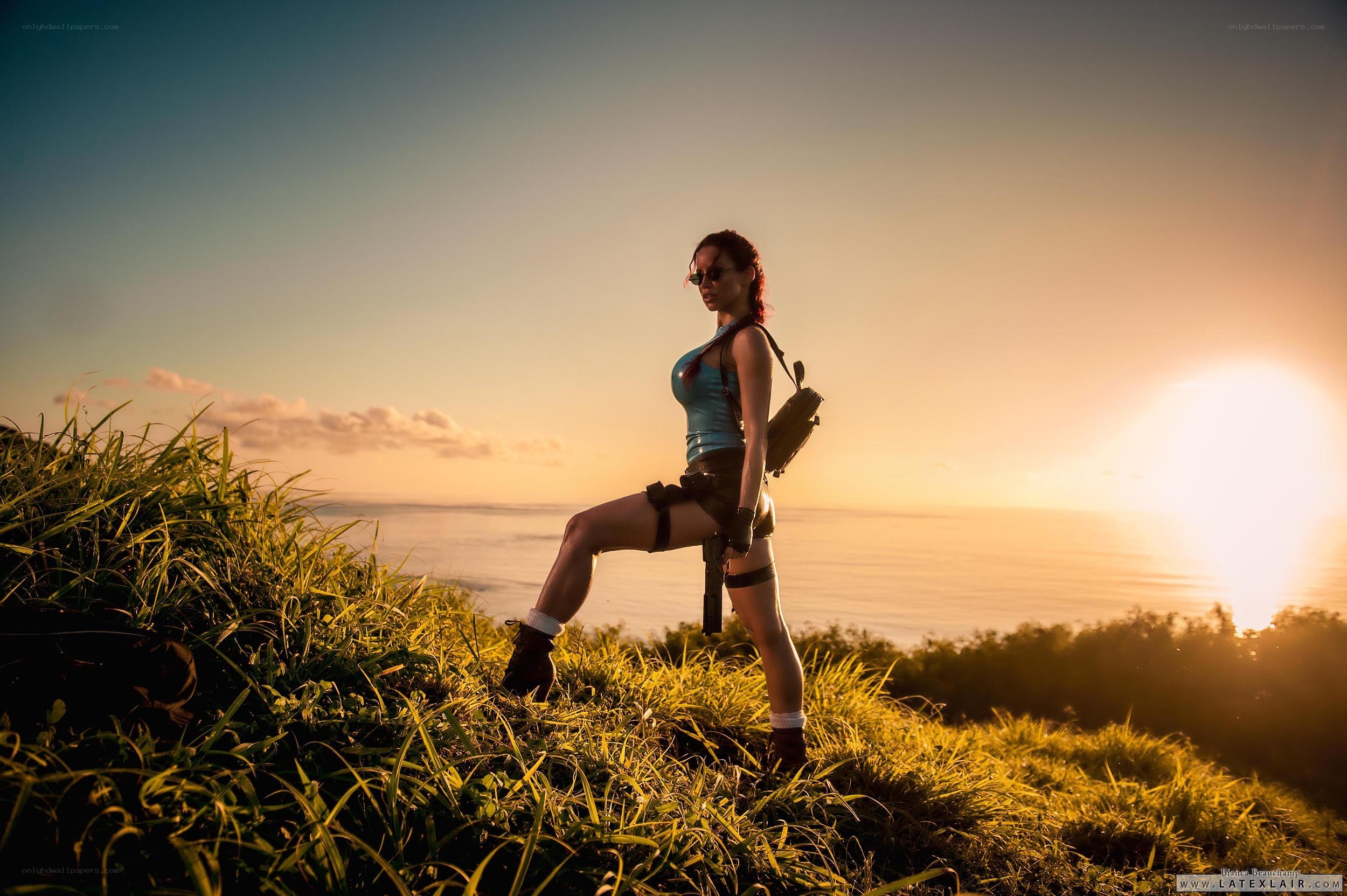 Lara Croft on a cliff at sunset