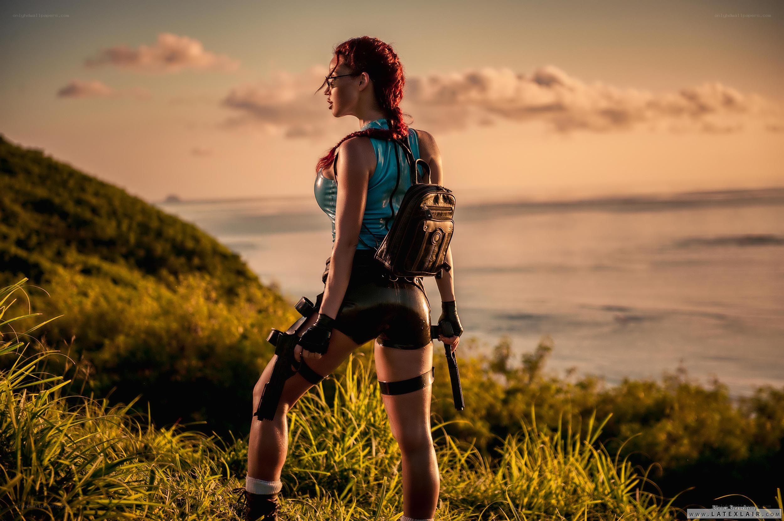 Lara Croft on a cliff at sunset