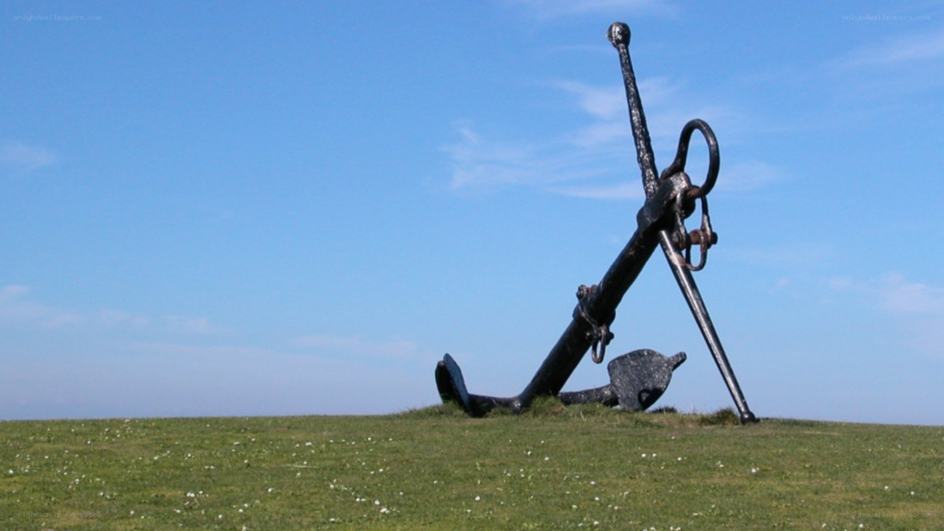 Large anchor on a grassy hill