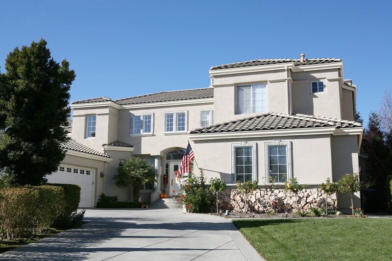 Large beige house with American flag