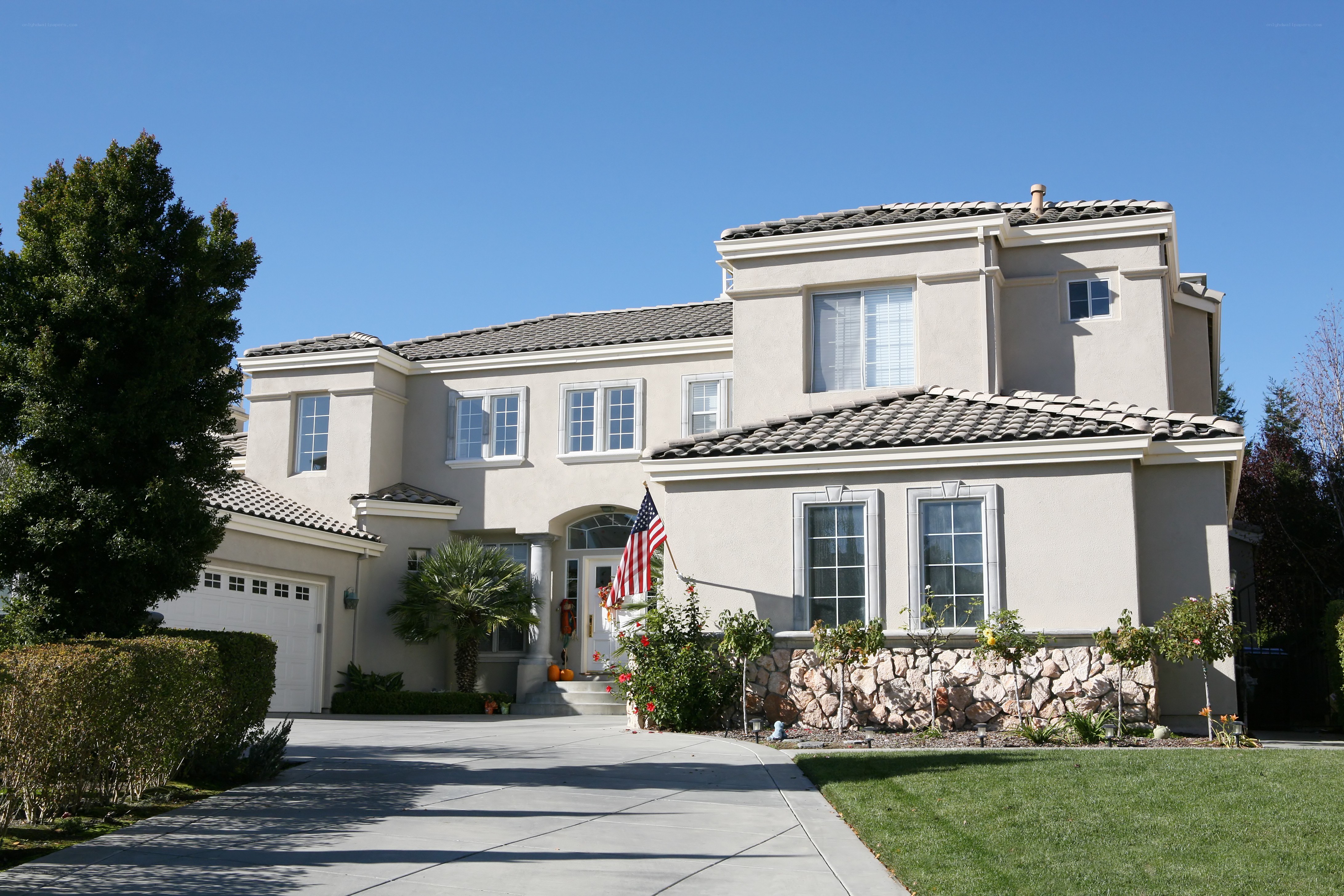 Large beige house with American flag