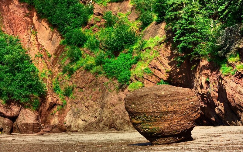 Large boulder on a rocky beach