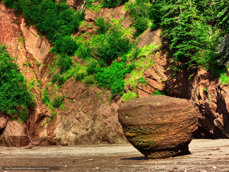 Large boulder on rocky beach