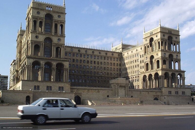 Large building with white car