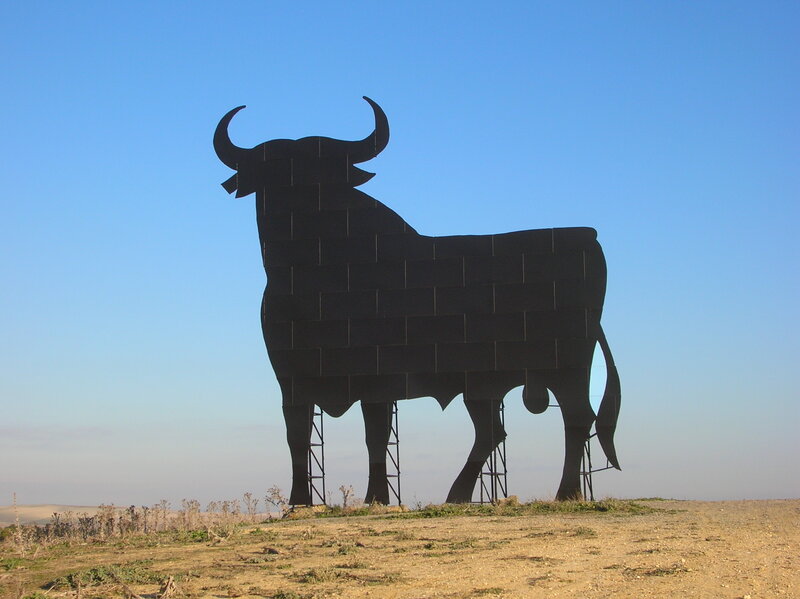 Large bull sculpture in field
