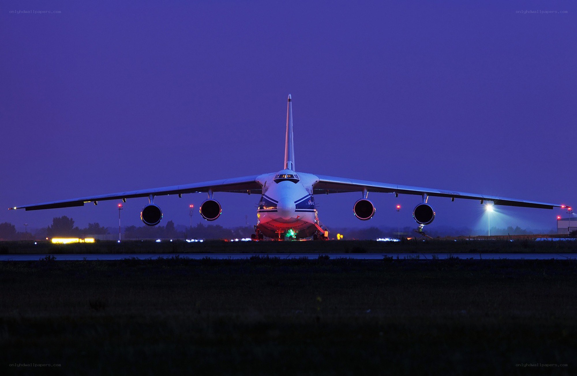 Large cargo plane on runway at night