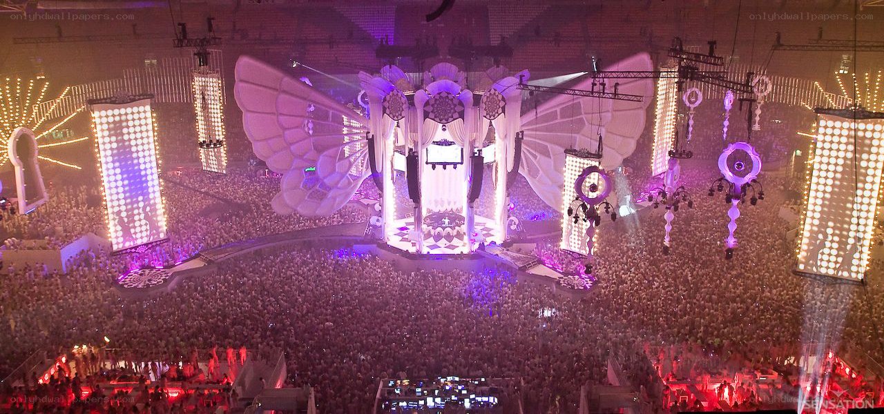 Large concert crowd with stage wings