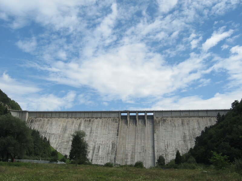 Large concrete dam under blue sky
