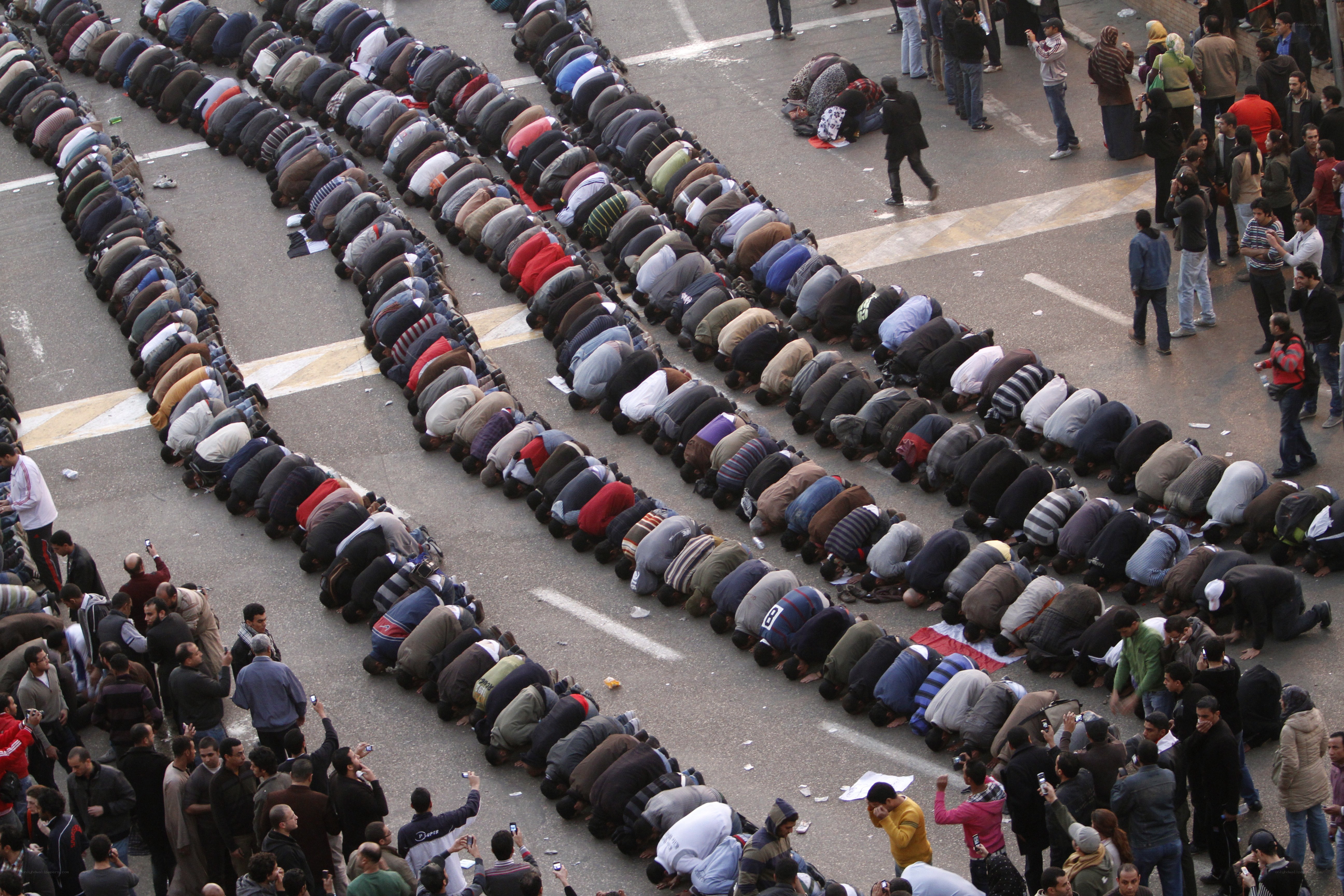 Large group praying in street