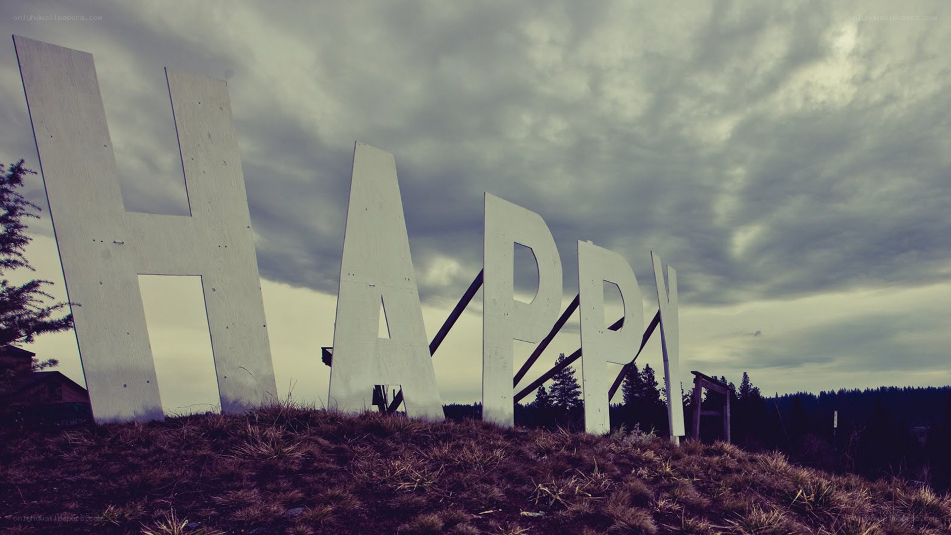 Large HAPPY sign on a hill