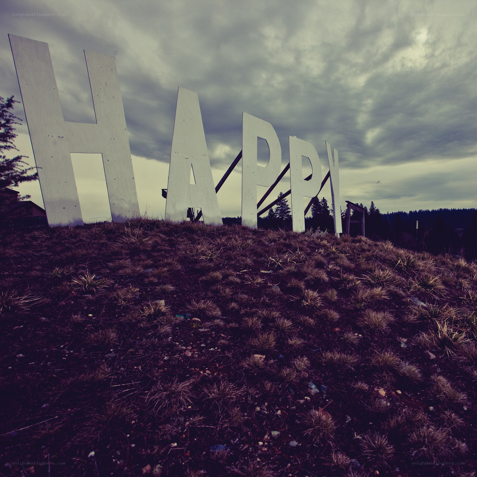 Large HAPPY sign on a hill