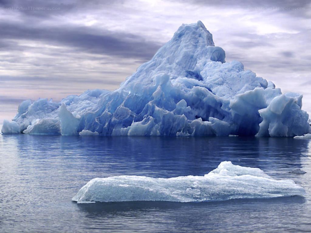 Large iceberg floating in calm water