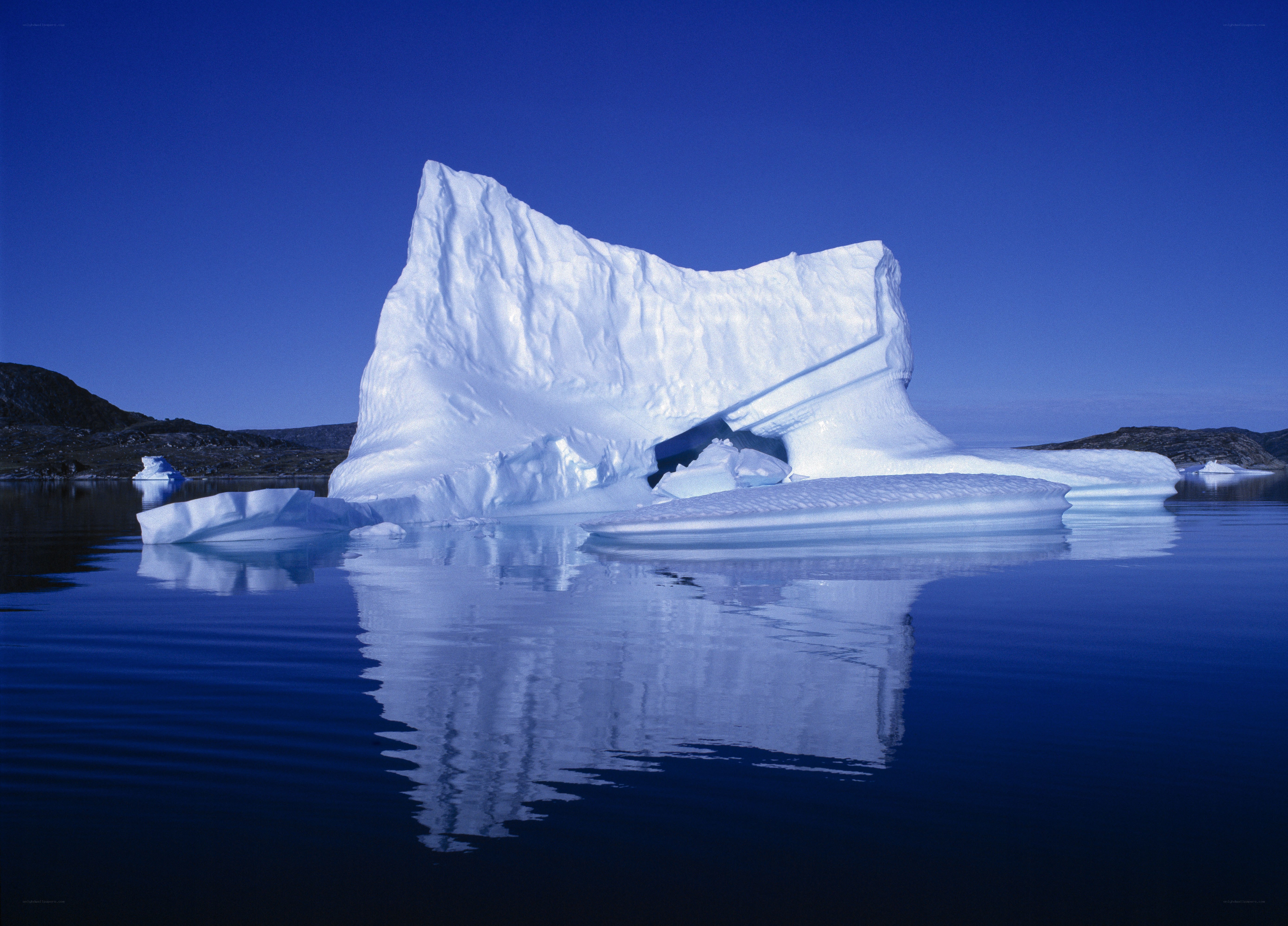 Large iceberg floating in calm water