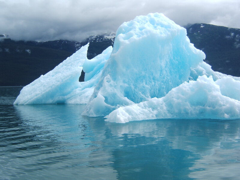 Large iceberg floating in calm water