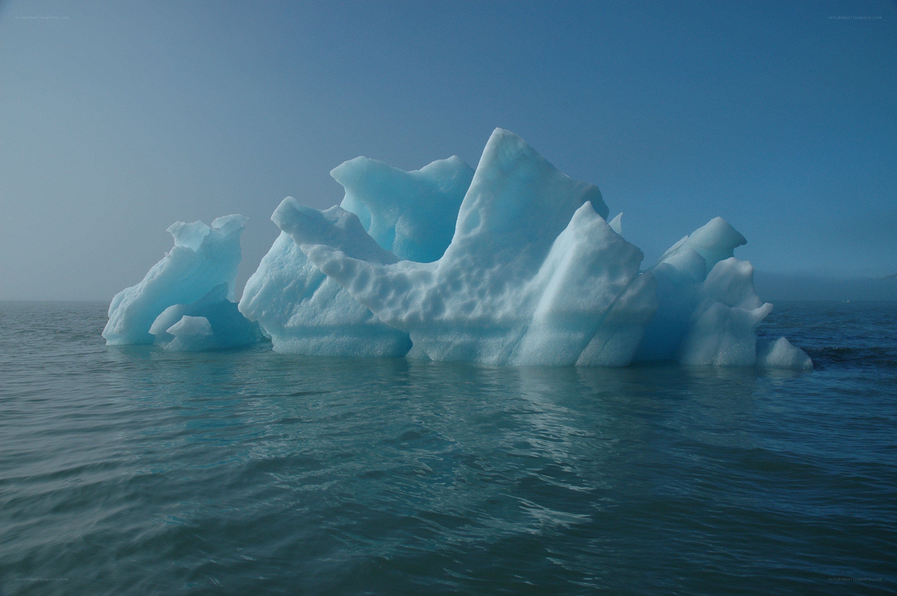 Large iceberg floating in calm water