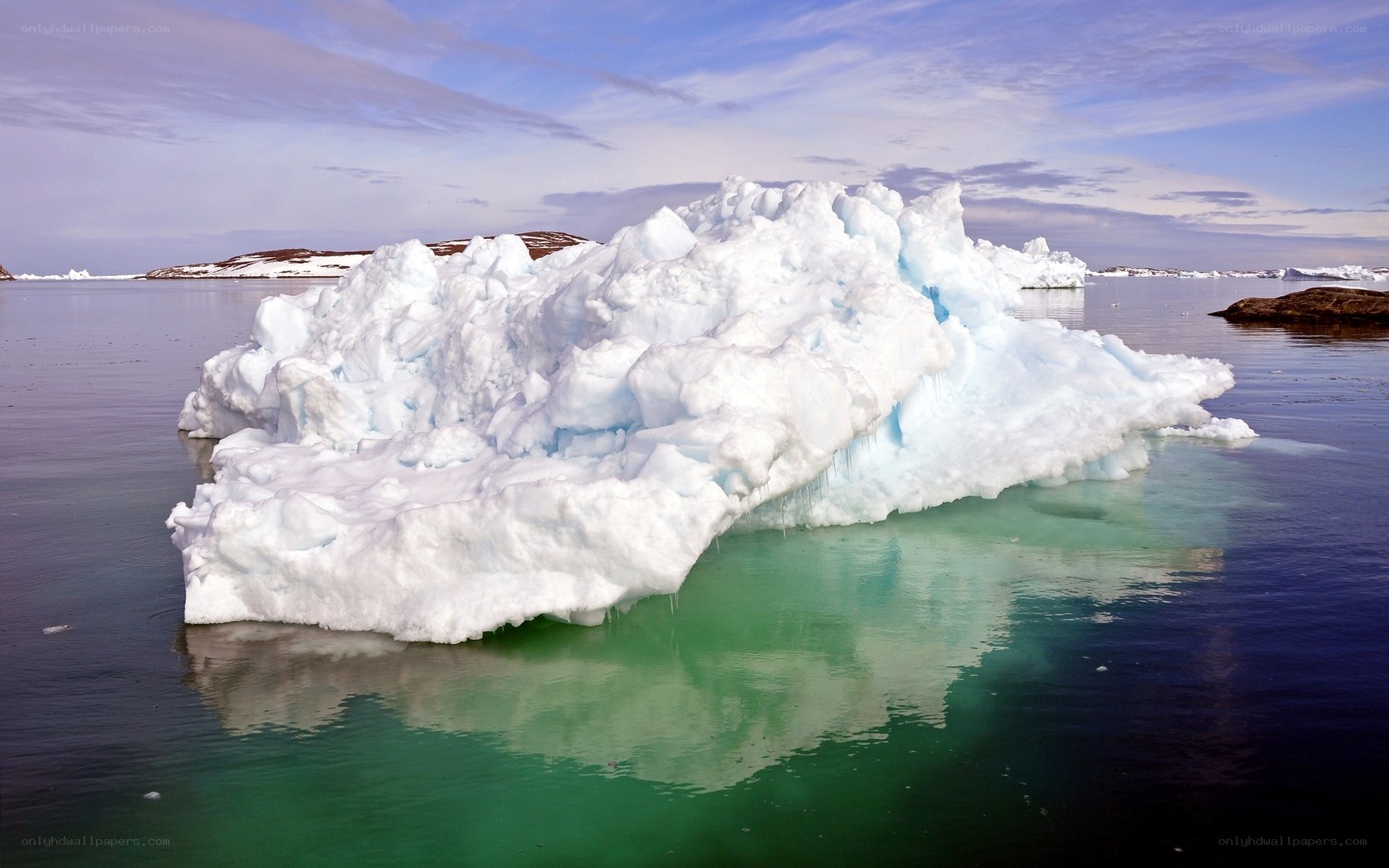Large iceberg floating in calm water