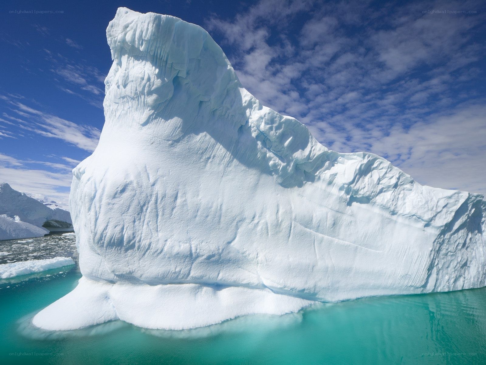 Large iceberg floating in turquoise water