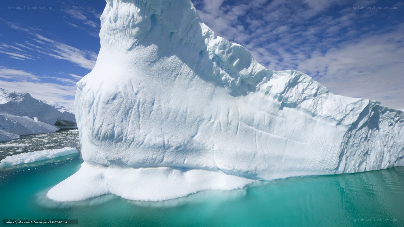 Large iceberg floating in turquoise water