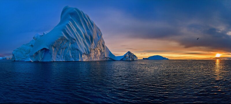 Large Iceberg in Ocean — Blue, Serene, Sunset