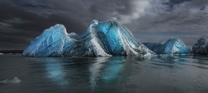 Large Iceberg in Water — Blue, Dramatic, Photograph, Clouds