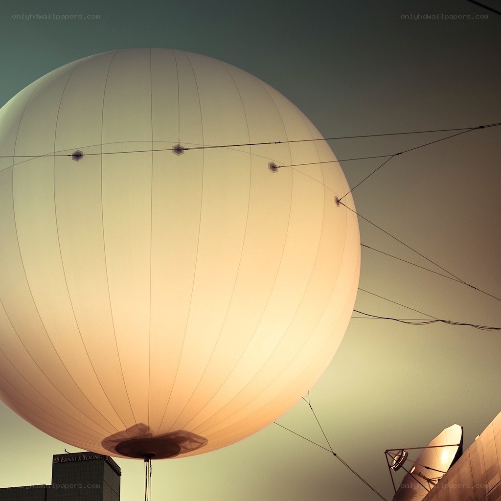 Large illuminated balloon in city