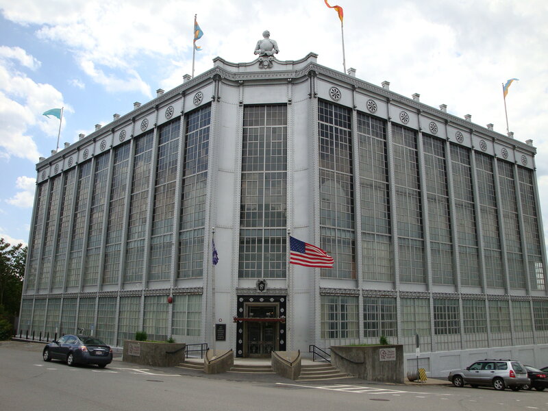 large industrial building with flags