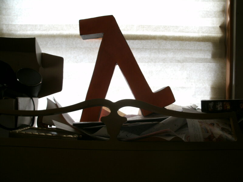 Large letter A on cluttered desk