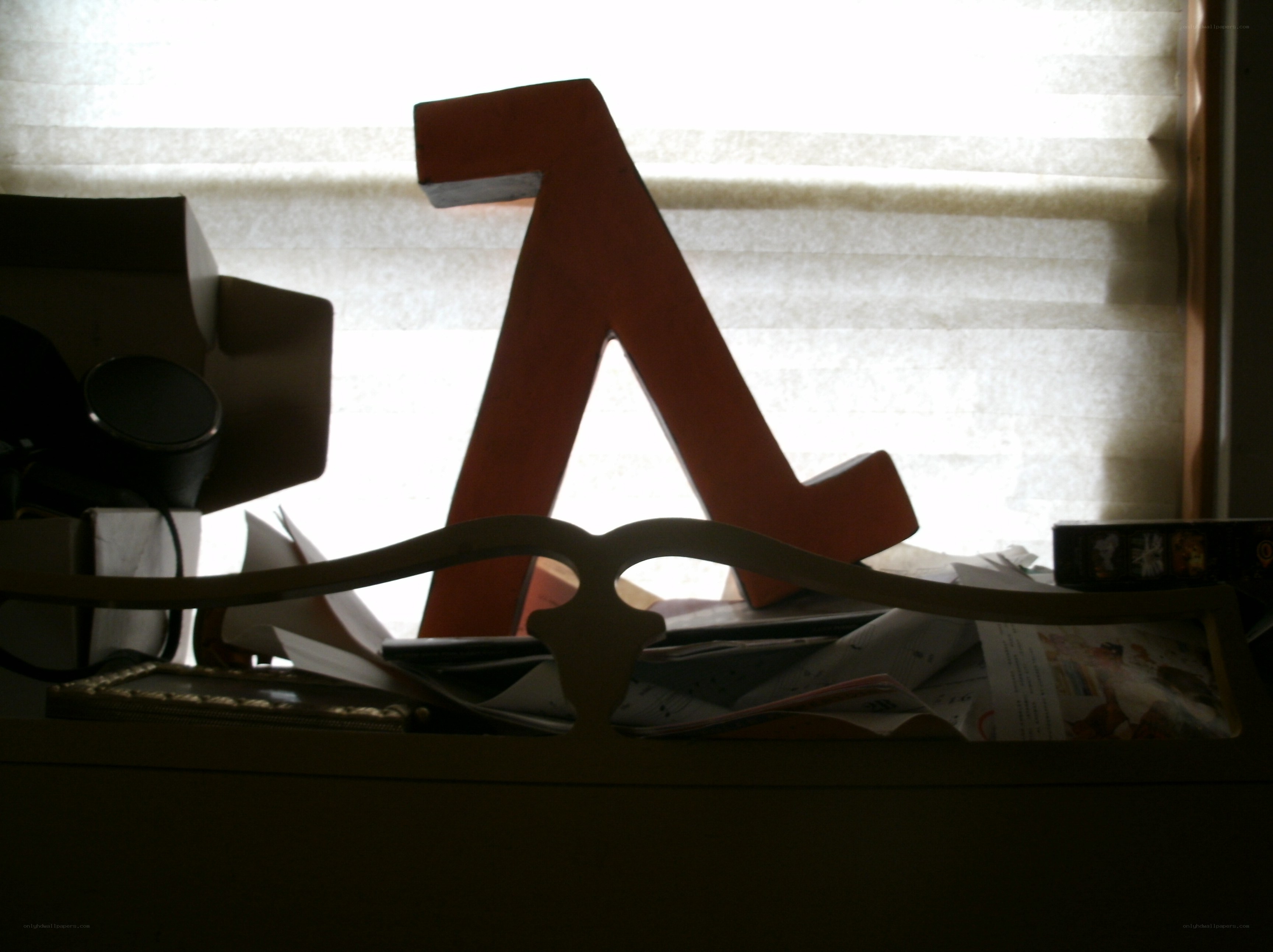 Large letter A on cluttered desk