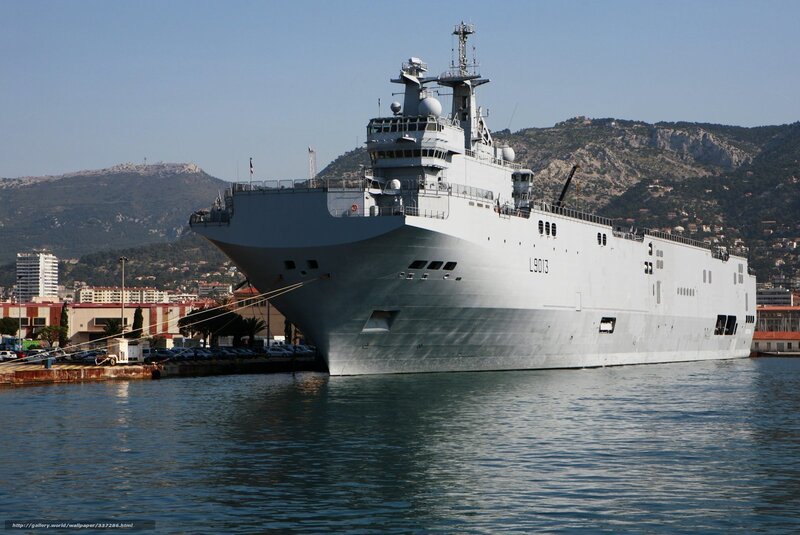Large military ship docked at port