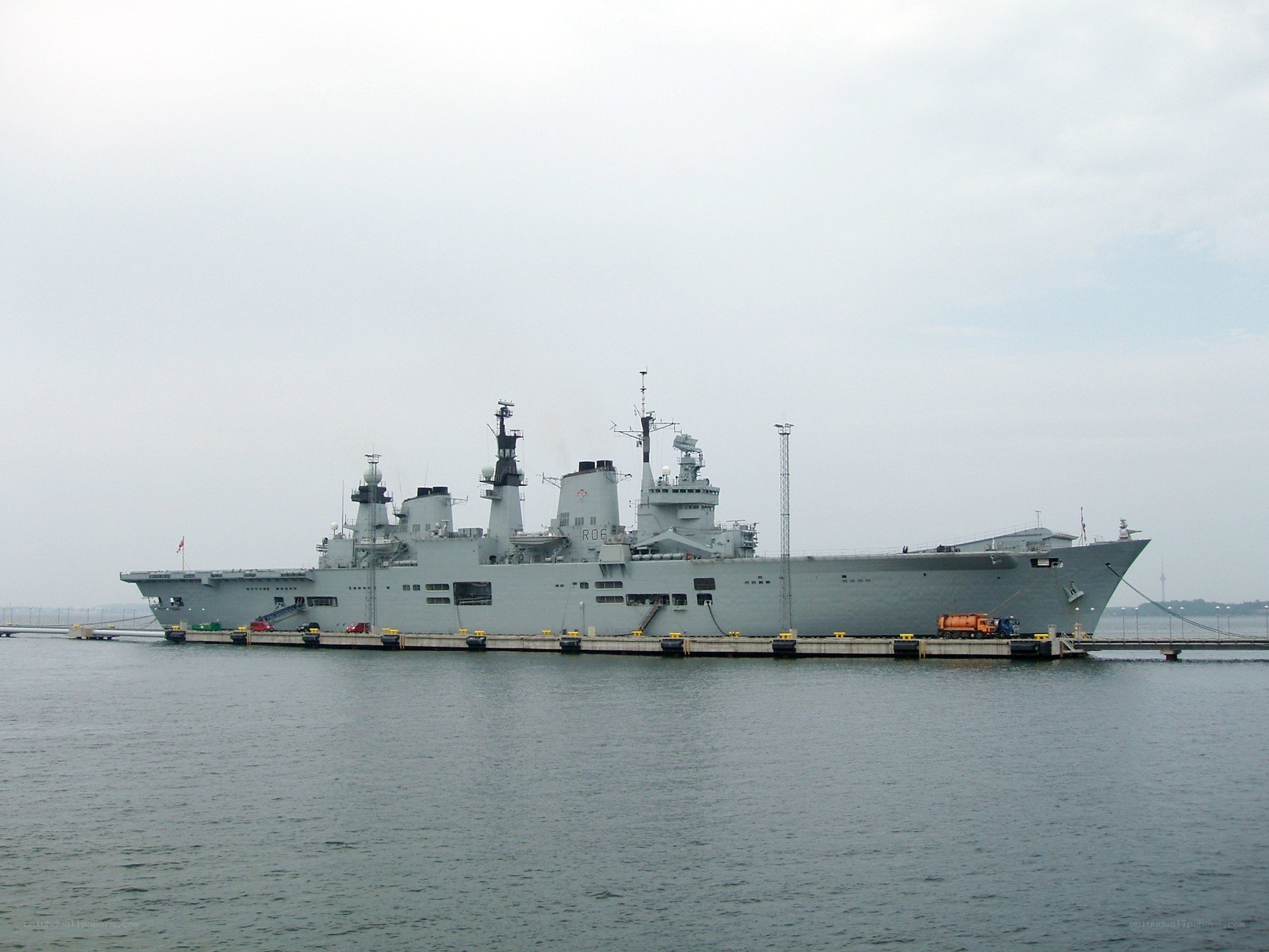 Large naval ship docked at port