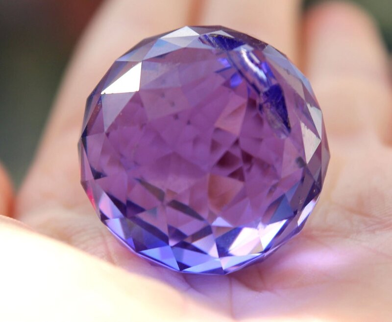large purple gemstone in hand