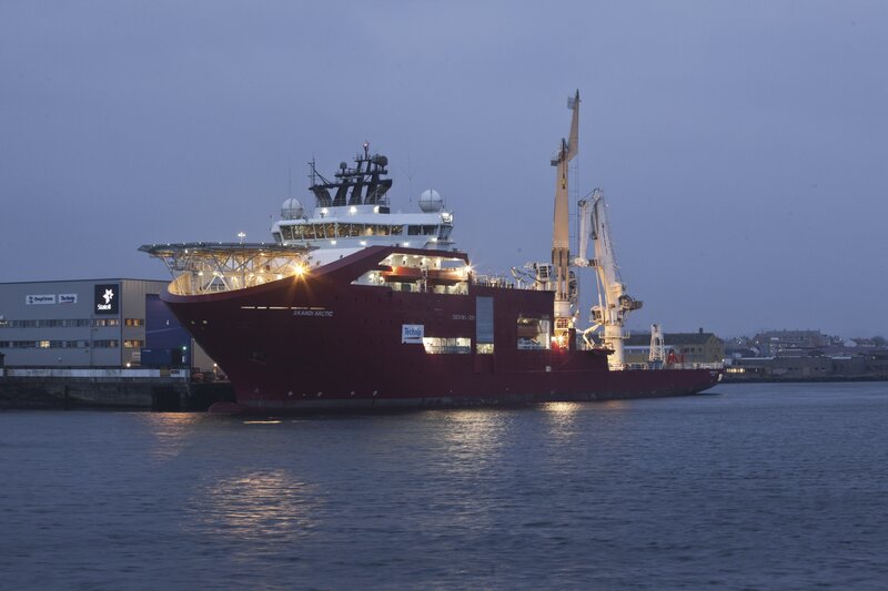 Large red ship at port