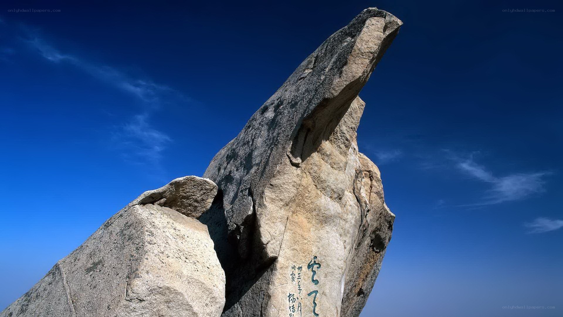 Large rock formation against blue sky