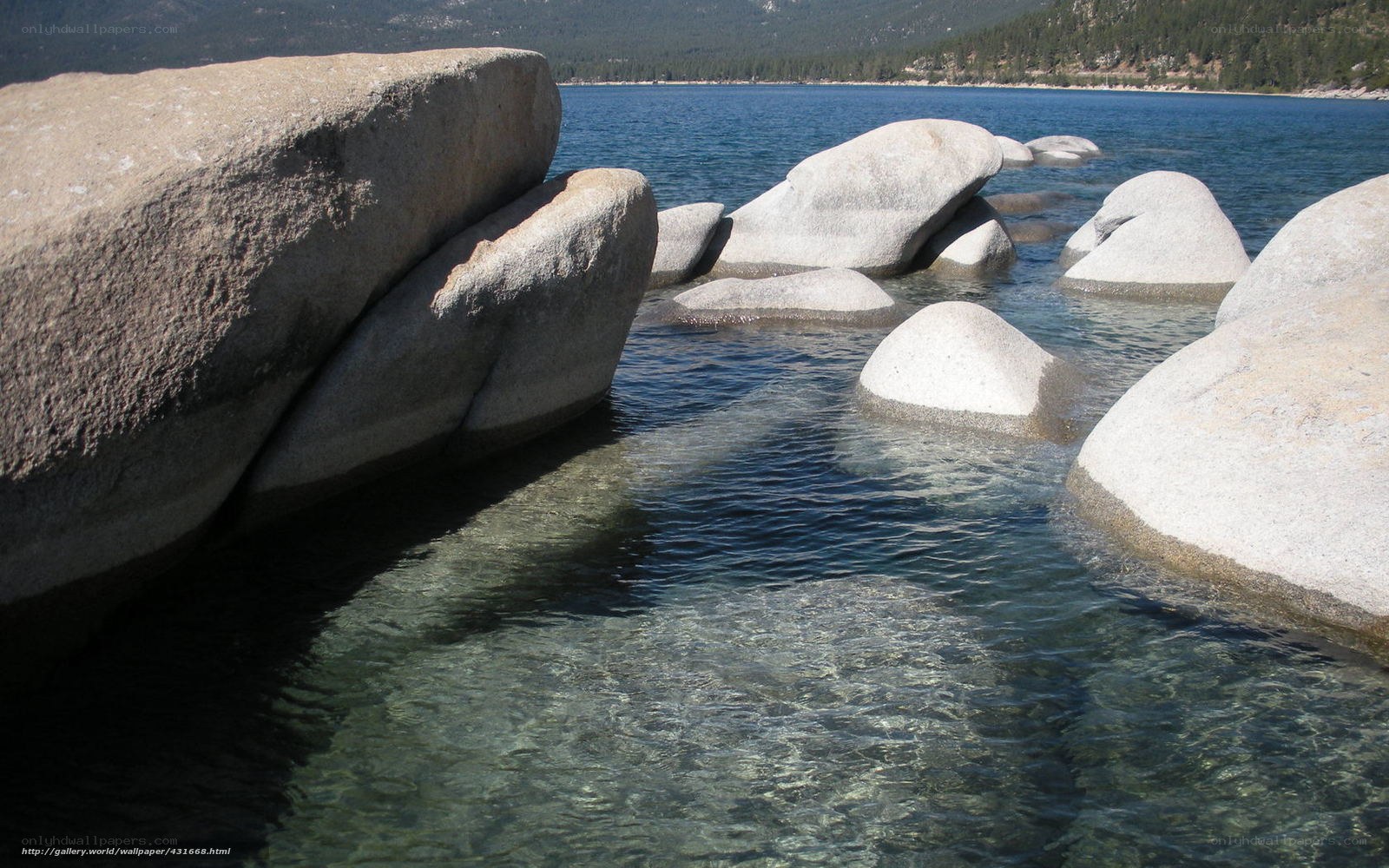 Large rocks in clear lake water