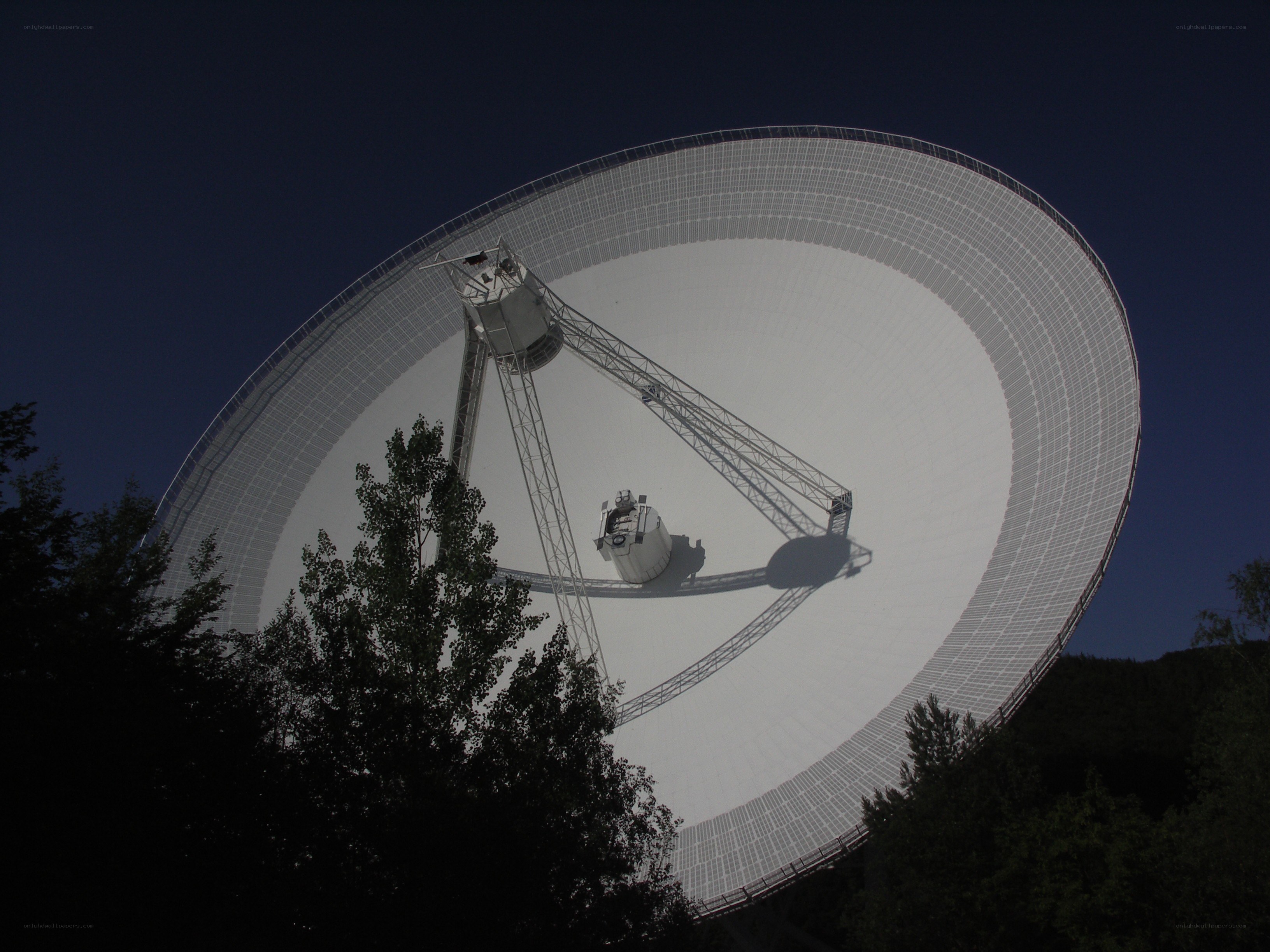 Large satellite dish at night