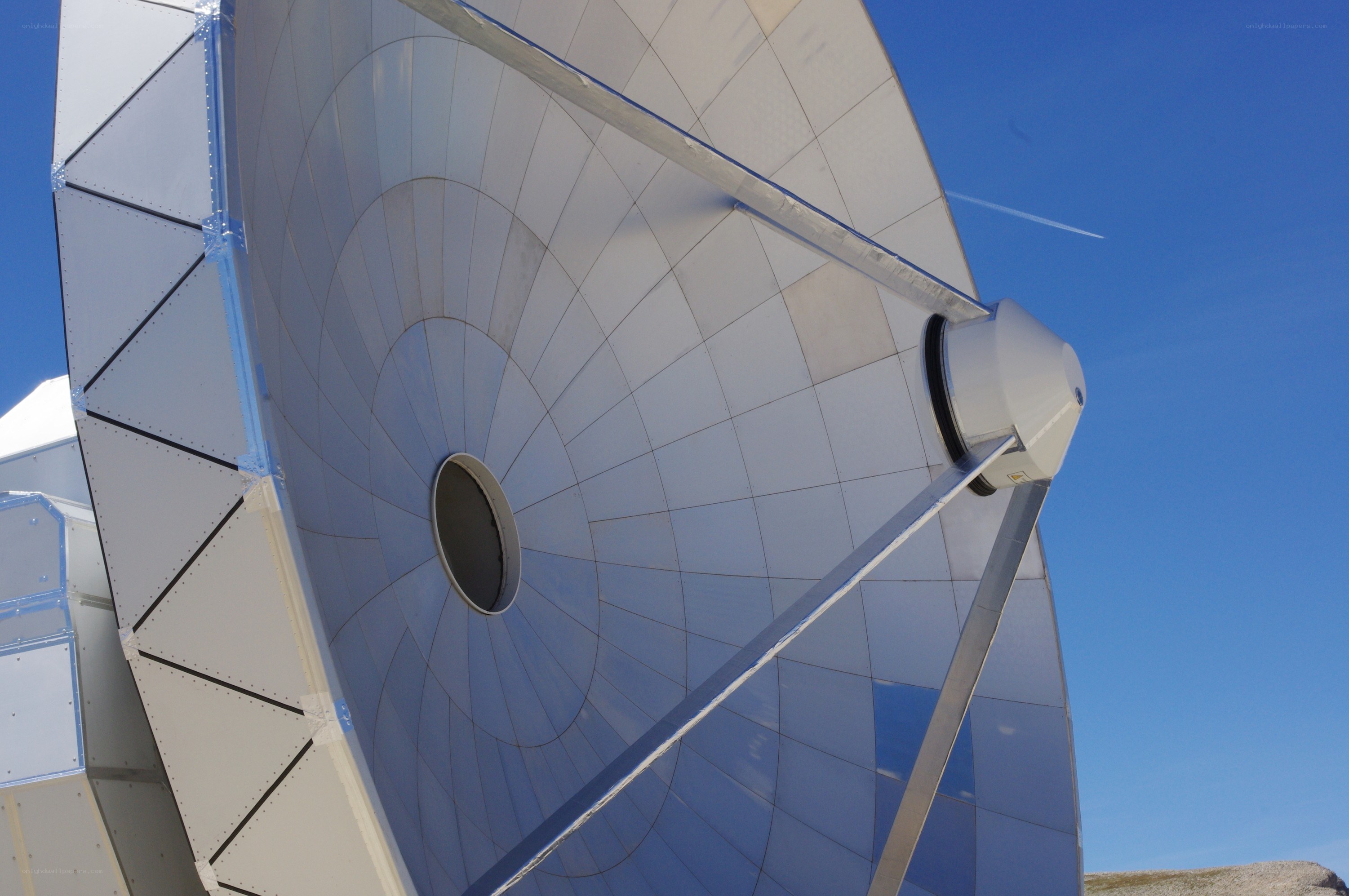 Large satellite dish under blue sky