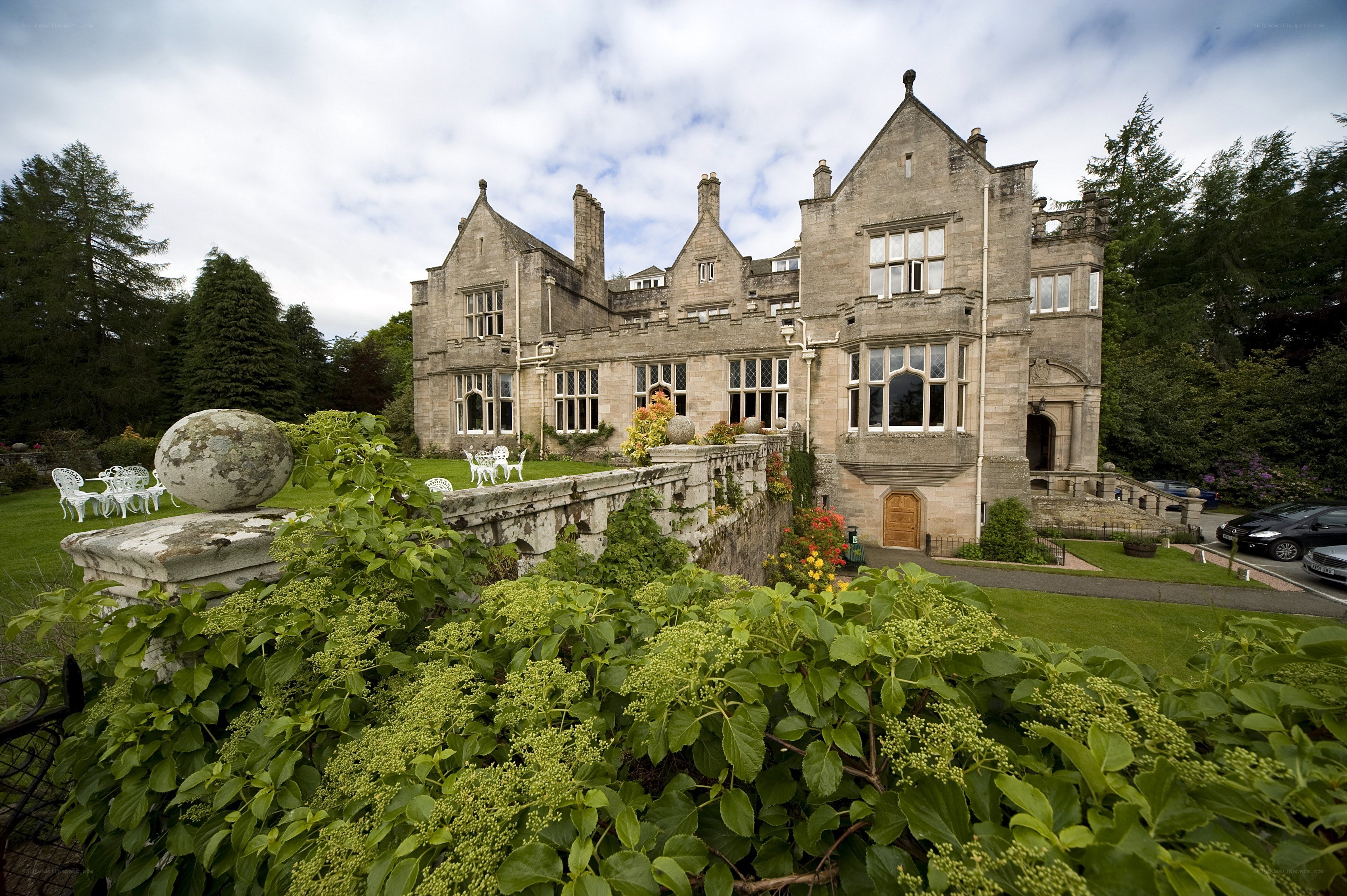 large stone mansion with garden